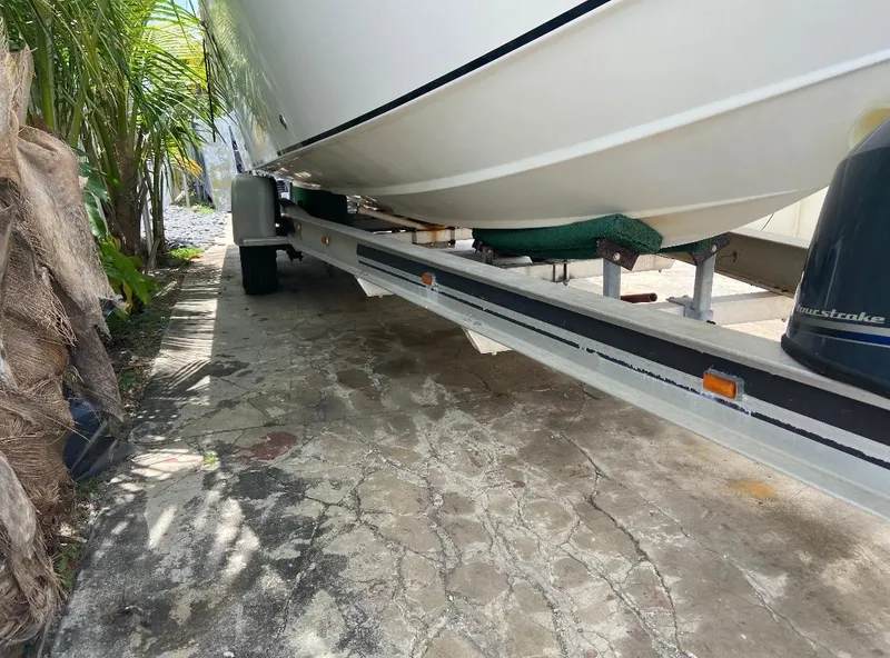 Slide: The Image of 1993 Fountain Walk Around boat on trailer, parked on a stone driveway. - 10