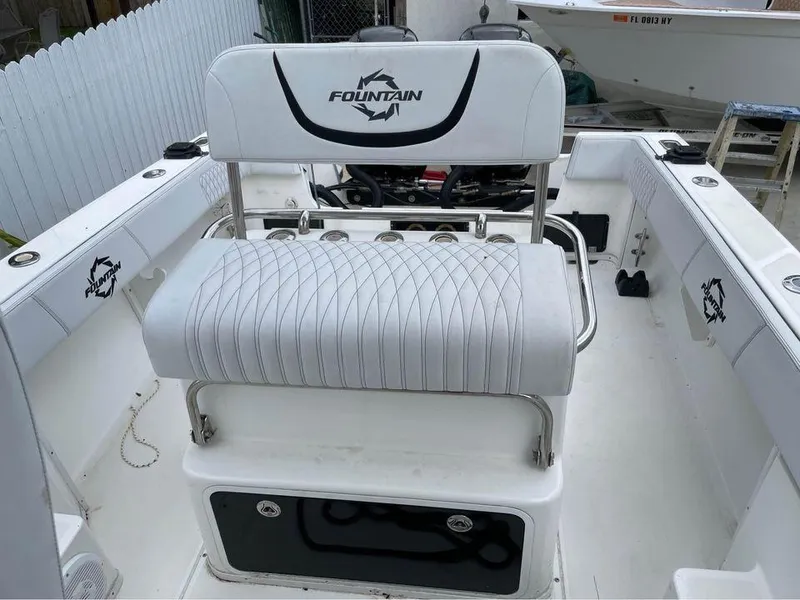 Slide: The Image of 1993 Fountain Walk Around boat interior with white seating and logo. - 5