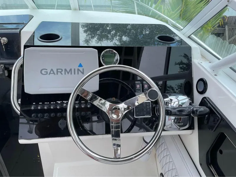 Slide: The Image of 1993 Fountain Walk Around boat dashboard with Garmin navigation system and steering wheel. - 7