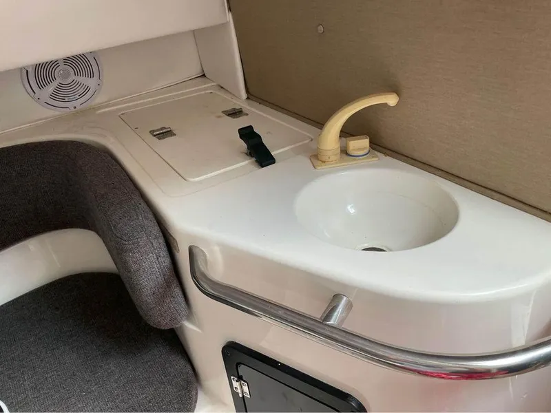 Slide: The Image of 1993 Fountain Walk Around boat interior with sink and seating area. - 8