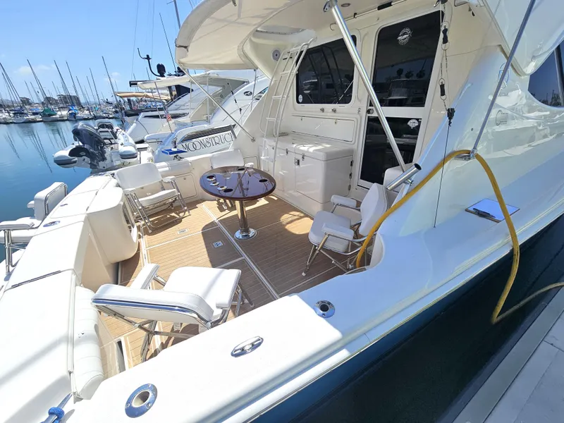 Slide: The Image of 2005 Riviera 42 Flybridge yacht docked at marina. - 13