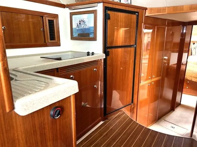 Slide: The Image of 2005 Riviera 42 Flybridge yacht interior with wood finish. - 19