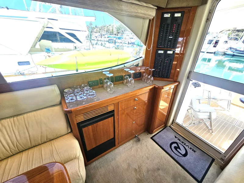 Slide: The Image of Interior of a 2005 Riviera 42 Flybridge yacht with elegant wood finish. - 23