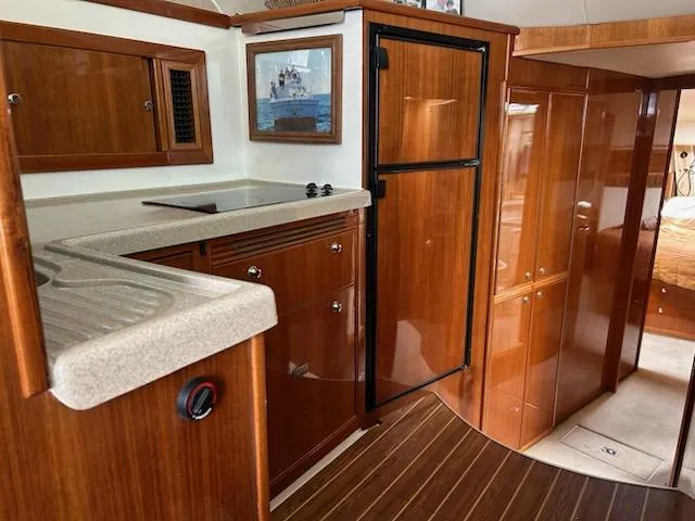 Slide: The Image of 2005 Riviera 42 Flybridge yacht interior with wood finish. - 31