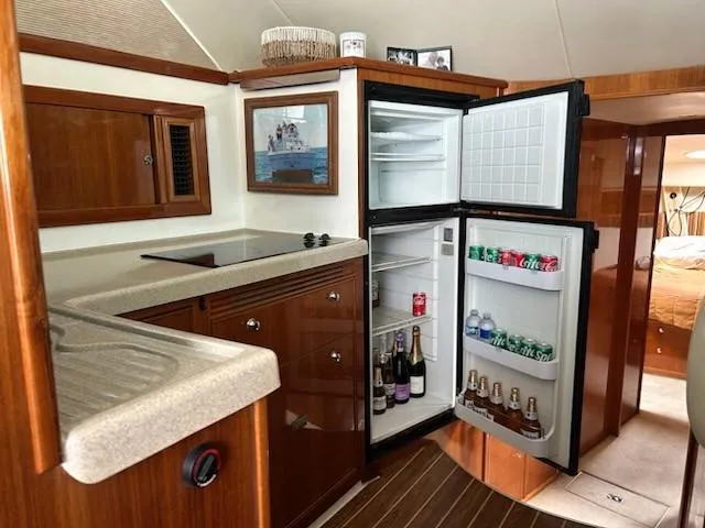Slide: The Image of Interior of 2005 Riviera 42 Flybridge with open kitchen and fridge. - 32