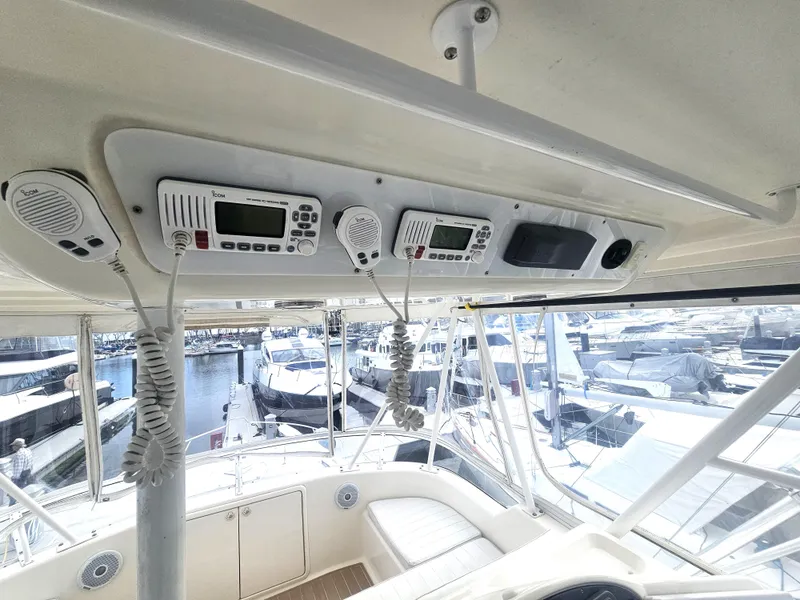 Slide: The Image of Riviera 42 Flybridge 2005, helm station with electronics and marina view. - 5