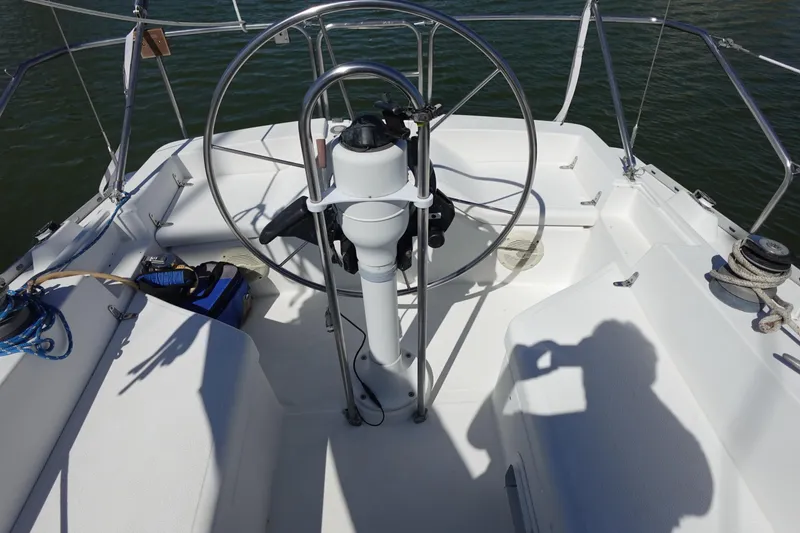 Slide: The Image of Cockpit of 1987 Hunter 310 sailboat with steering wheel and nautical equipment. - 10