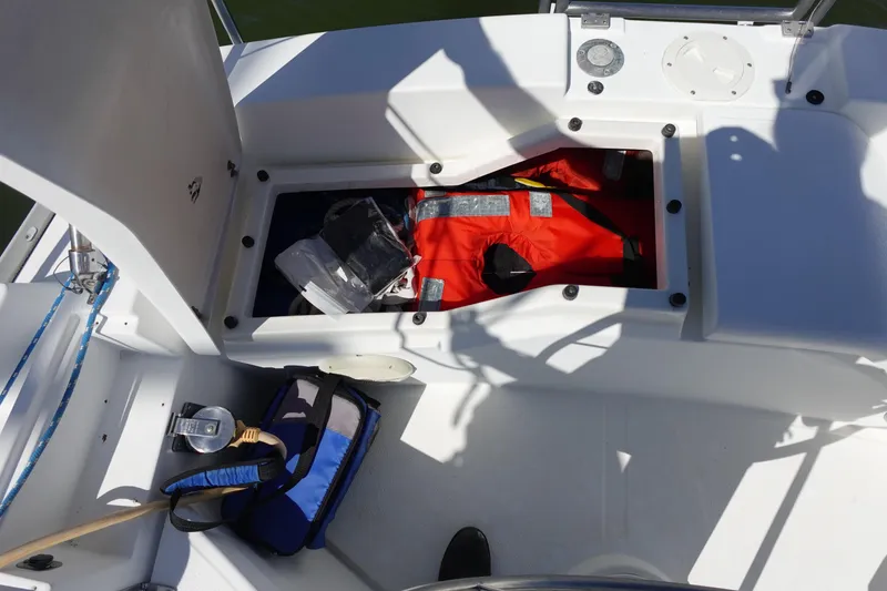 Slide: The Image of Open storage compartment on 1987 Hunter 310 sailboat with life jackets and equipment. - 11