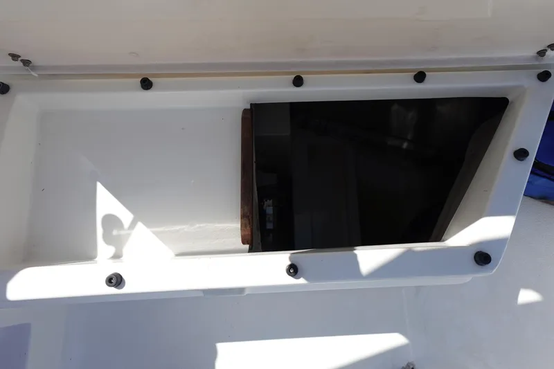Slide: The Image of Open storage compartment on a 1987 Hunter 310 boat, showing interior details. - 13