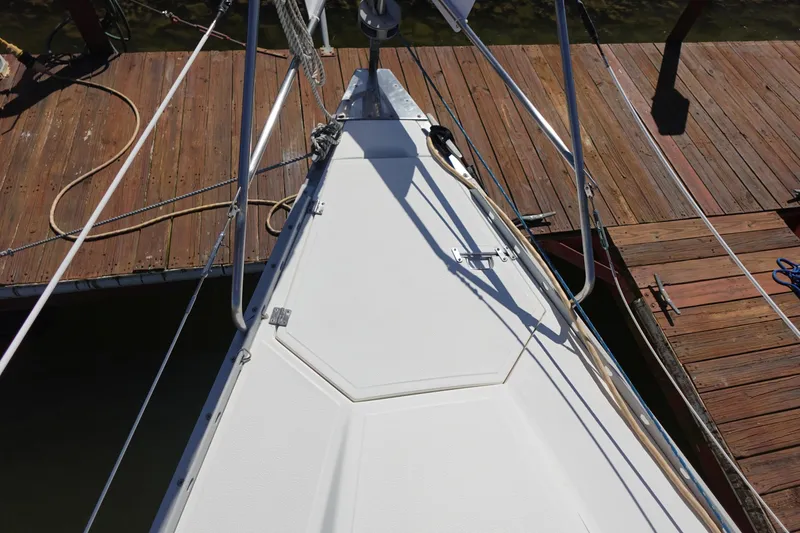 Slide: The Image of Bow of 1987 Hunter 310 sailboat docked at wooden pier. - 18