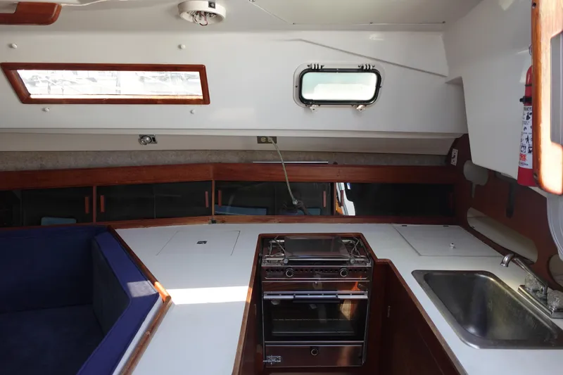 Slide: The Image of Interior of 1987 Hunter 310 sailboat with kitchen and seating area. - 26