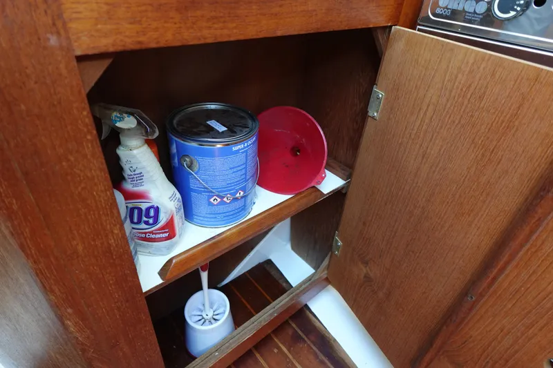 Slide: The Image of Wooden cabinet with cleaning supplies and paint can, Hunter 310, 1987 model. - 29