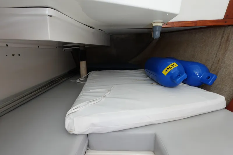 Slide: The Image of Interior cabin of a 1987 Hunter 310 sailboat with cushions and blue fenders. - 31