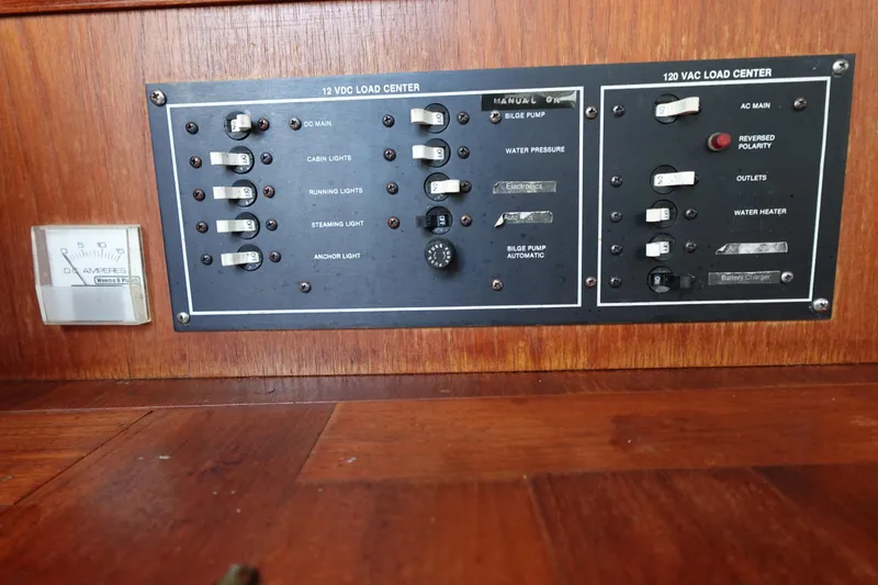 Slide: The Image of Control panel of a 1987 Hunter 310 boat with switches and gauges. - 33