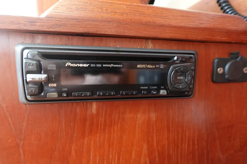 Slide: The Image of Pioneer car stereo installed in a 1987 Hunter 310 boat's wooden dashboard. - 34