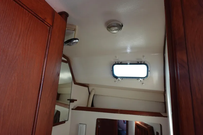 Slide: The Image of Interior of 1987 Hunter 310 sailboat with wooden cabinetry and porthole window. - 45