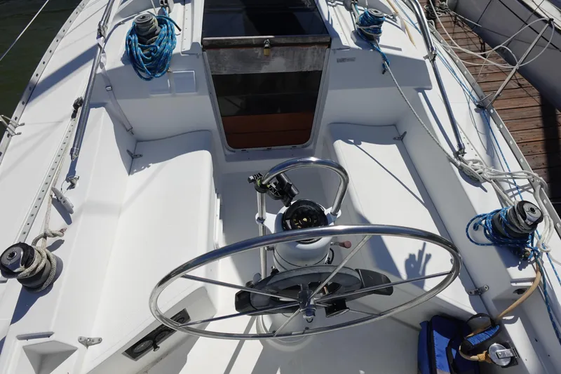 Slide: The Image of Cockpit of 1987 Hunter 310 sailboat with steering wheel and winches. - 8
