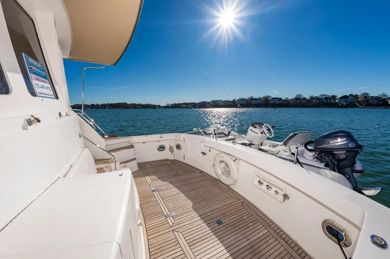 Slide: The Image of Grand Banks 49 Eastbay SX 2005 yacht deck under sunny skies on calm waters. - 11