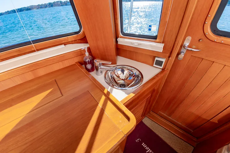 Slide: The Image of Interior of 2005 Grand Banks 49 Eastbay SX with wood finish and sink. - 30
