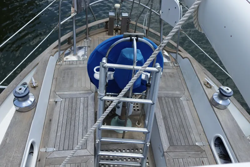 Slide: The Image of 1985 Tayana 37 Cutter sailboat deck with steering wheel and winches. - 10