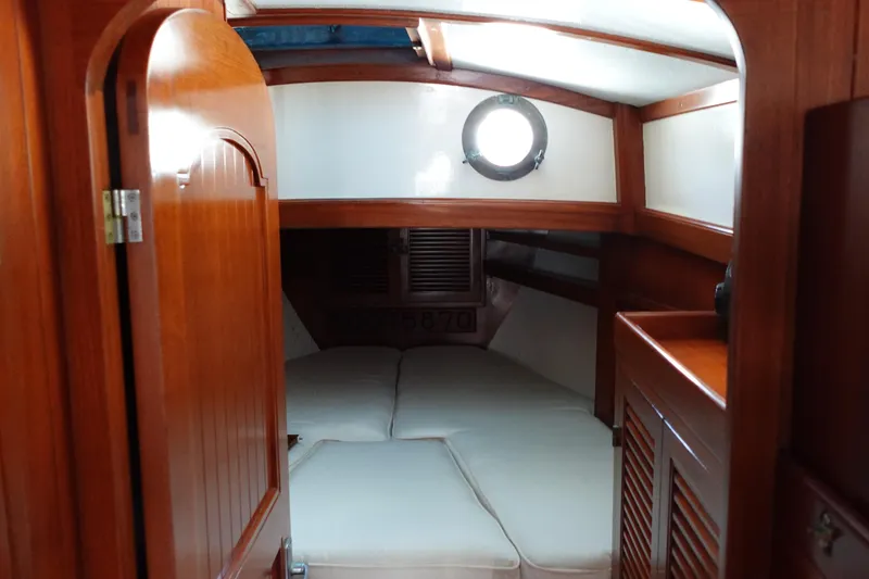 Slide: The Image of Cozy cabin interior of 1985 Tayana 37 Cutter sailboat with wooden finish and porthole. - 17