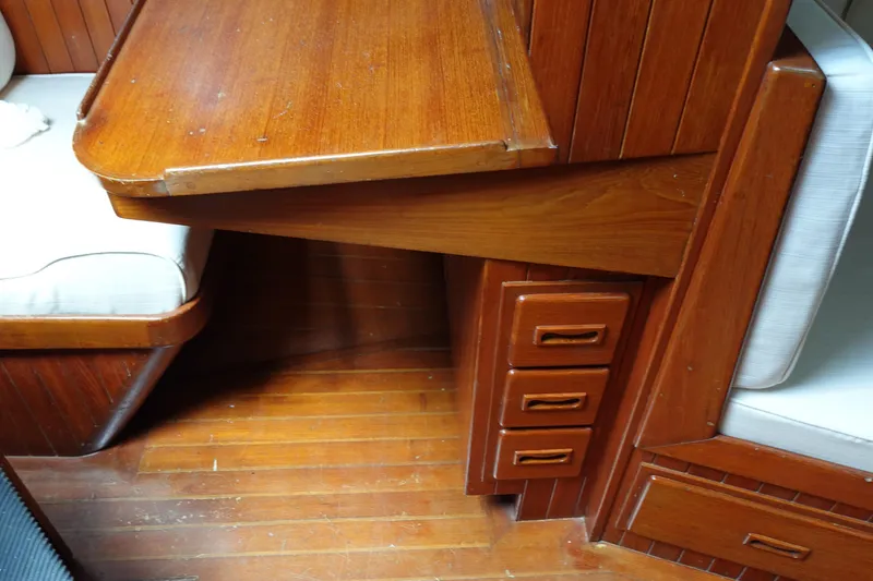 Slide: The Image of Interior of 1985 Tayana 37 Cutter with wooden table and drawers. - 19