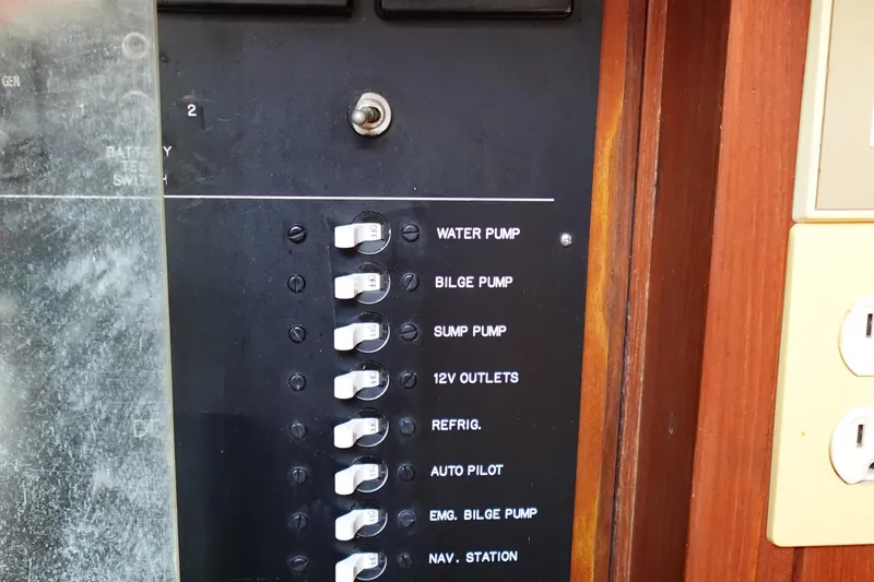 Slide: The Image of Control panel of a 1985 Tayana 37 Cutter with labeled switches for various functions. - 22