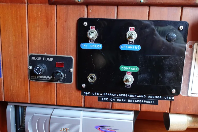 Slide: The Image of Control panel of a 1985 Tayana 37 Cutter with bilge pump and navigation switches. - 29