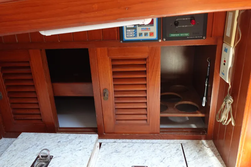 Slide: The Image of Interior of 1985 Tayana 37 Cutter with wooden cabinets and control panels. - 35