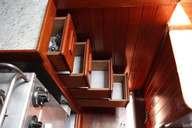 Slide: The Image of Wooden interior drawers in a 1985 Tayana 37 Cutter sailboat kitchen. - 41