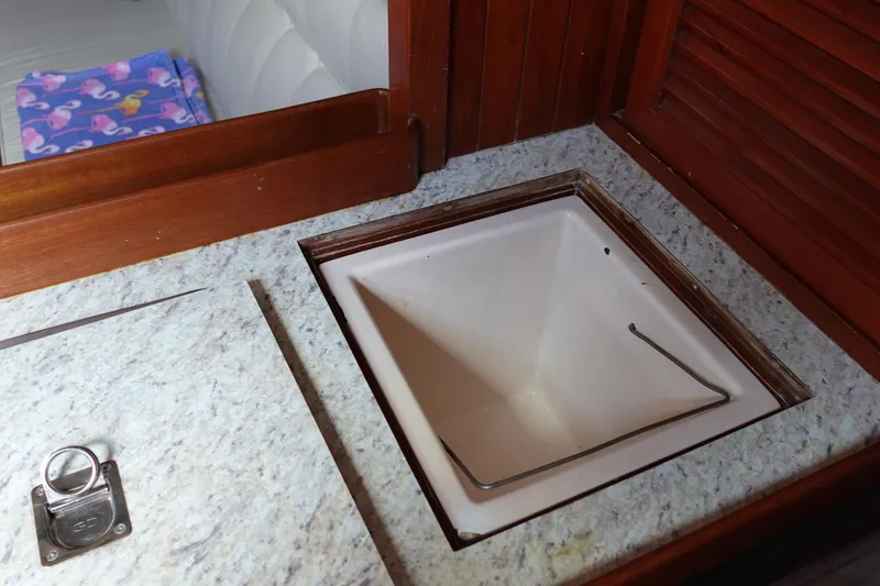 Slide: The Image of Interior of 1985 Tayana 37 Cutter showing a built-in sink and countertop. - 44