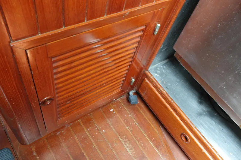 Slide: The Image of Wooden interior of 1985 Tayana 37 Cutter sailboat, featuring a louvered cabinet door. - 47