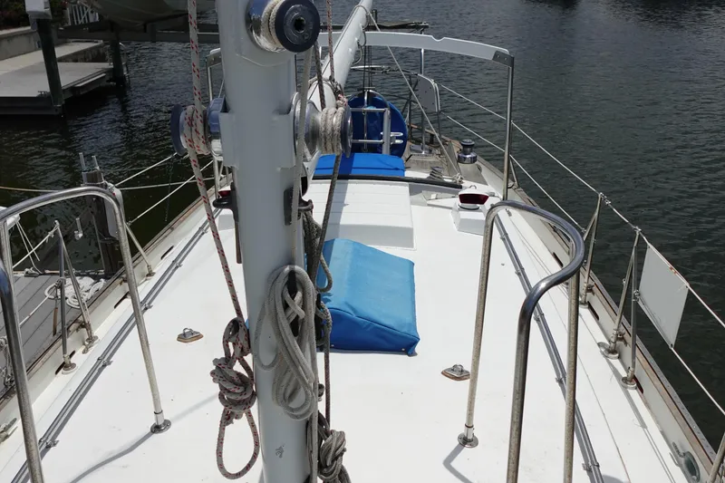 Slide: The Image of 1985 Tayana 37 Cutter sailboat deck with blue cushions and rigging. - 8