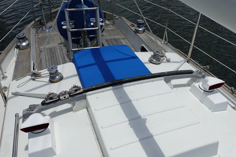 Slide: The Image of Deck view of 1985 Tayana 37 Cutter sailboat with blue cover and winches. - 9