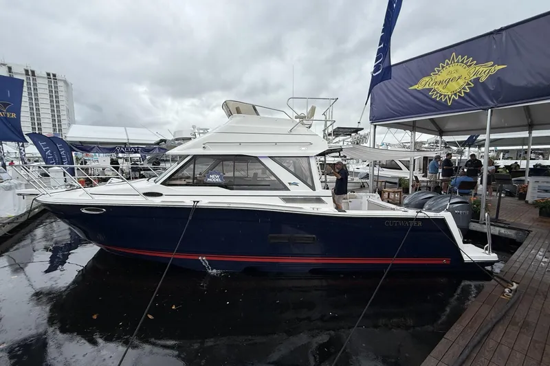 The Image of 2026 Cutwater C-288 CB boat displayed at a marina under cloudy skies. - 0