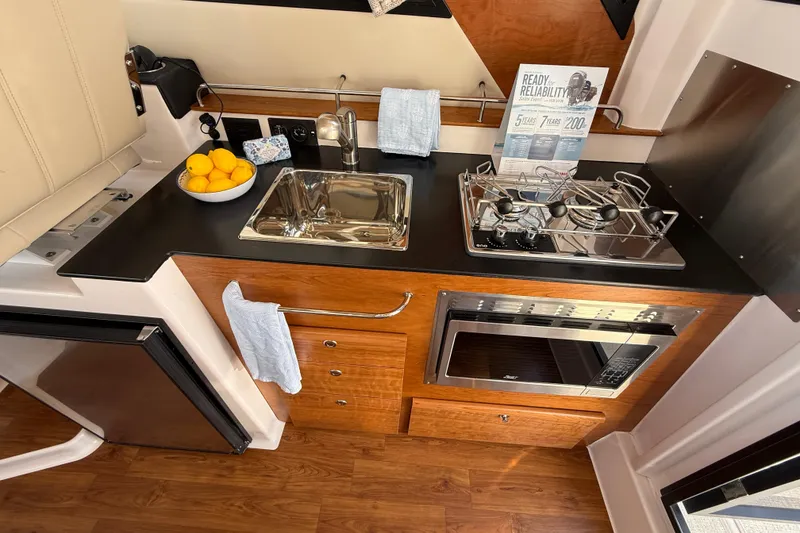 Slide: The Image of Modern kitchen in 2026 Cutwater C-288 CB boat with sink, stove, and microwave. - 12