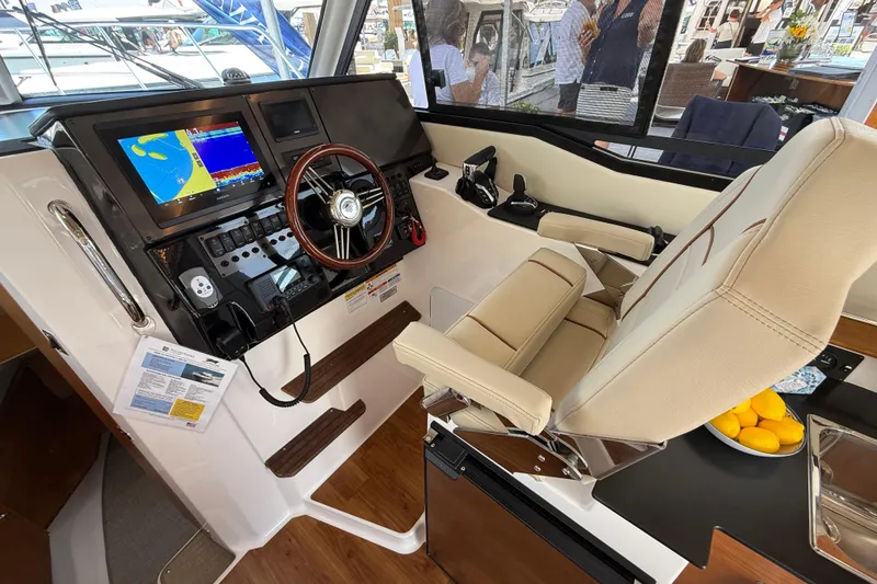 Slide: The Image of Helm of 2026 Cutwater C-288 CB boat with navigation display and controls. - 14