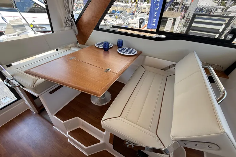 Slide: The Image of Interior of 2026 Cutwater C-288 CB boat with dining area and wooden table. - 15