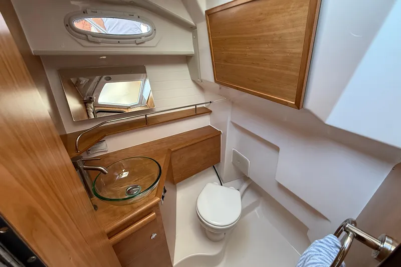 Slide: The Image of 2026 Cutwater C-288 CB boat bathroom with wood accents and glass sink. - 17
