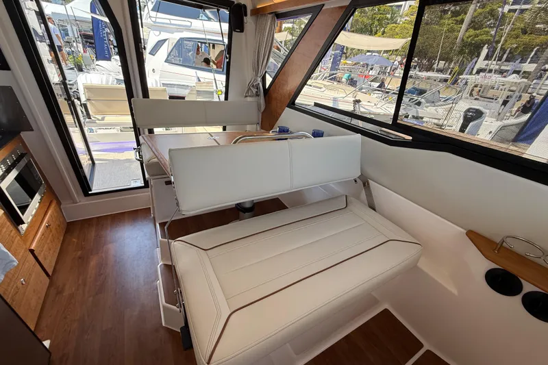 Slide: The Image of Interior of 2026 Cutwater C-288 CB boat with white seating and wood accents. - 20