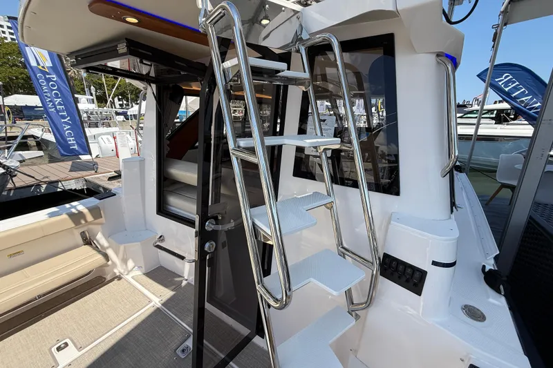 Slide: The Image of 2026 Cutwater C-288 CB yacht interior with sleek stairs and modern design elements. - 23