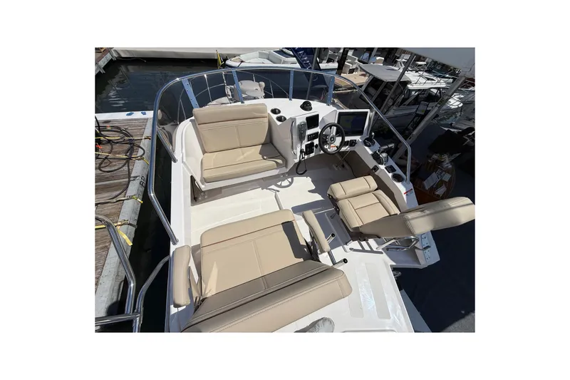 Slide: The Image of 2026 Cutwater C-288 CB boat cockpit with beige seating and modern controls. - 25