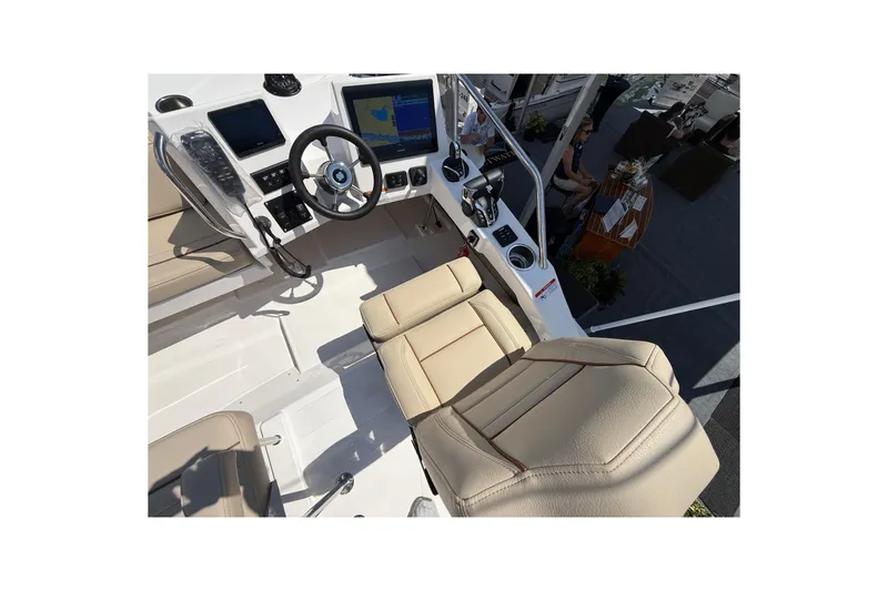 Slide: The Image of Interior view of 2026 Cutwater C-288 CB boat cockpit with steering wheel and navigation screens. - 26