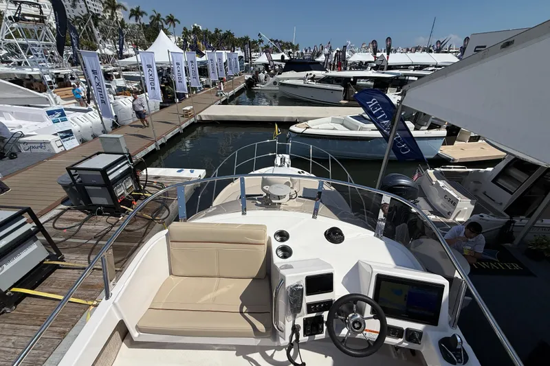 Slide: The Image of 2026 Cutwater C-288 CB boat at marina, showcasing helm and seating area. - 29