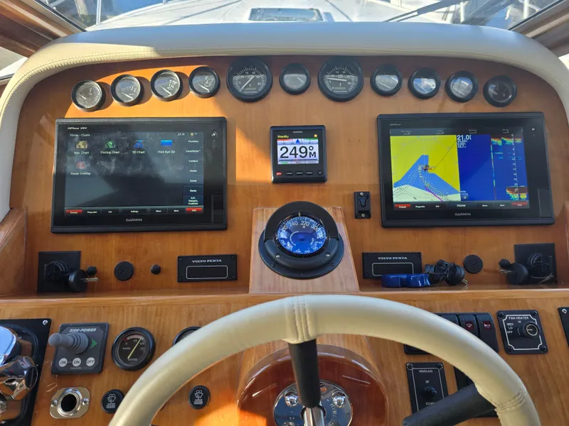 Slide: The Image of 2005 Navigator 44C helm with Garmin displays and controls. - 12