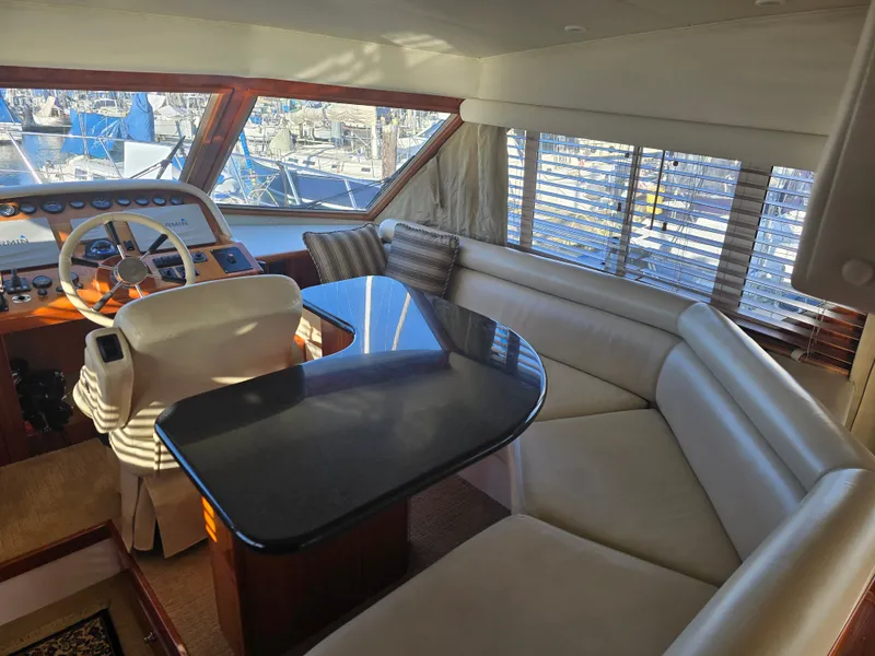 Slide: The Image of Interior of a 2005 Navigator 44C yacht with helm and seating area. - 16