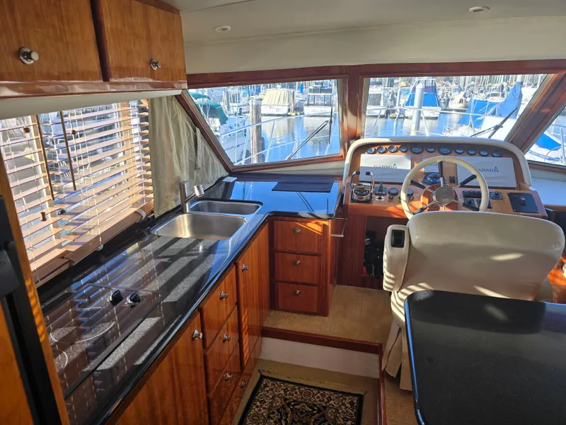 Slide: The Image of Interior of a 2005 Navigator 44C yacht with helm and kitchen. - 17