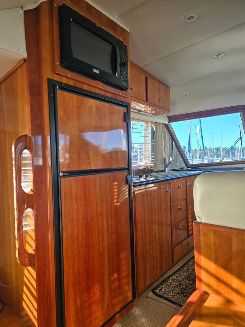 Slide: The Image of Interior of 2005 Navigator 44C yacht with wooden cabinetry and appliances. - 19