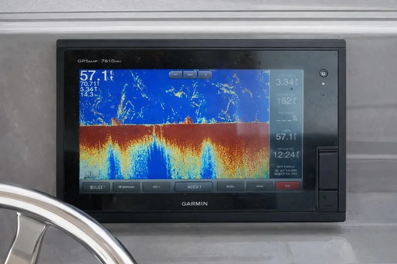 Slide: The Image of 2015 Pursuit DC 265 Dual Console boat bathroom with sink and toilet. - 11