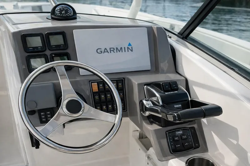 Slide: The Image of 2015 Pursuit DC 265 Dual Console dashboard with steering wheel and navigation display. - 9